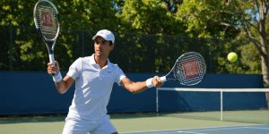 Beginner practicing forehand swing on outdoor tennis court